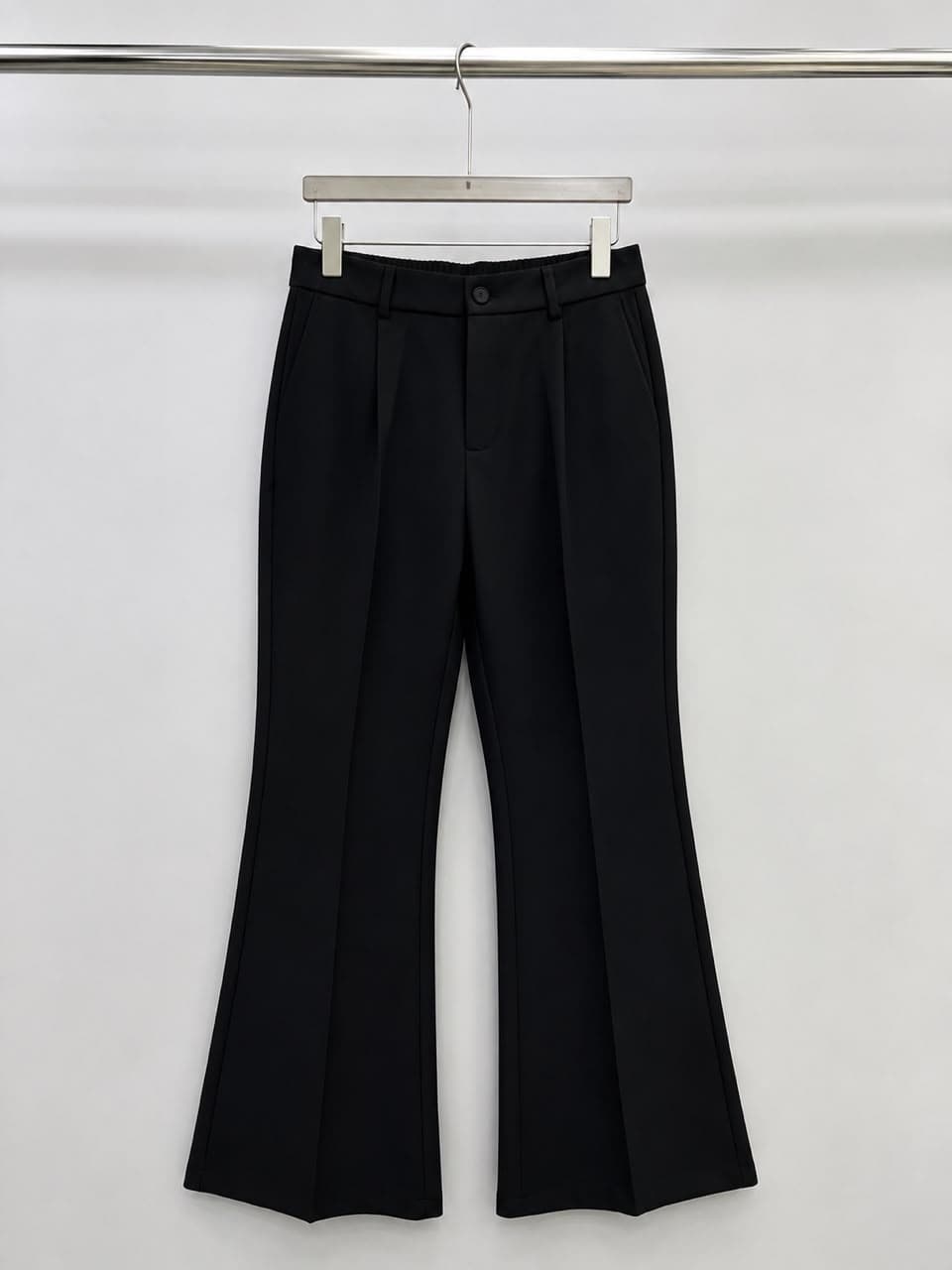 Black high-waisted flare trousers.