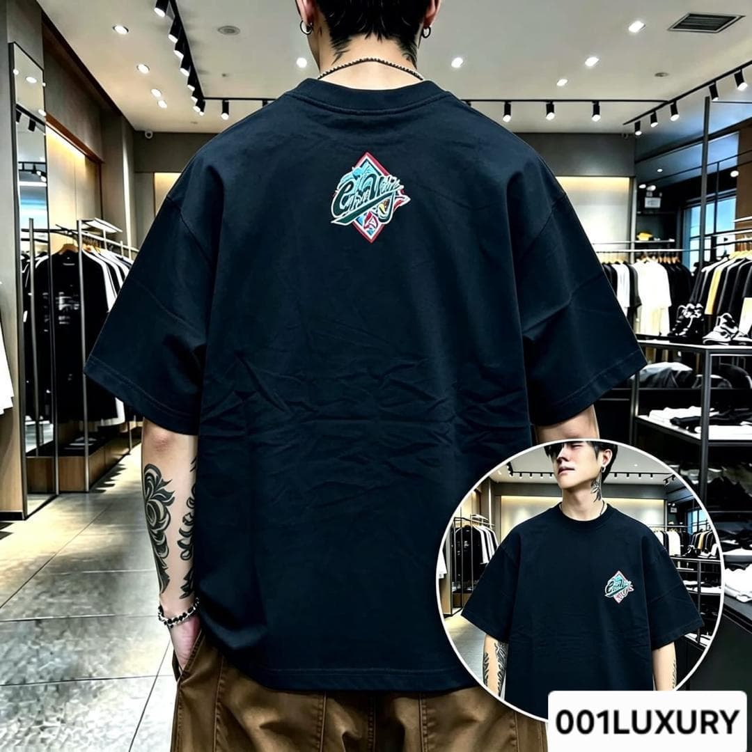 Man in black oversized T-shirt displaying diamond logo graphic on the back with front view inset.