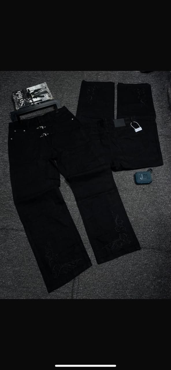 Model wearing blue baggy jeans with white splatter and distressing; inset of back view.