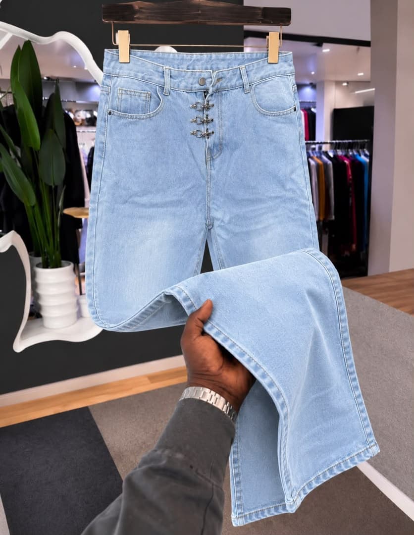 Model in green baggy jeans with multiple colorful patches; inset shows back view with PURPLE tag.