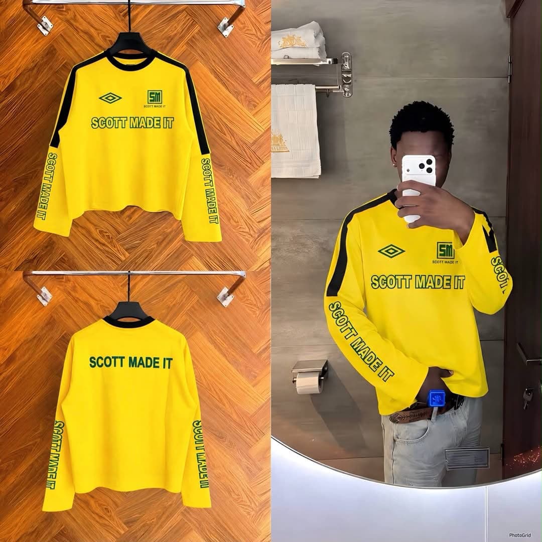 Yellow Scott Made It cropped long sleeve sweatshirt with black accents displayed on hanger and in mirror selfie.