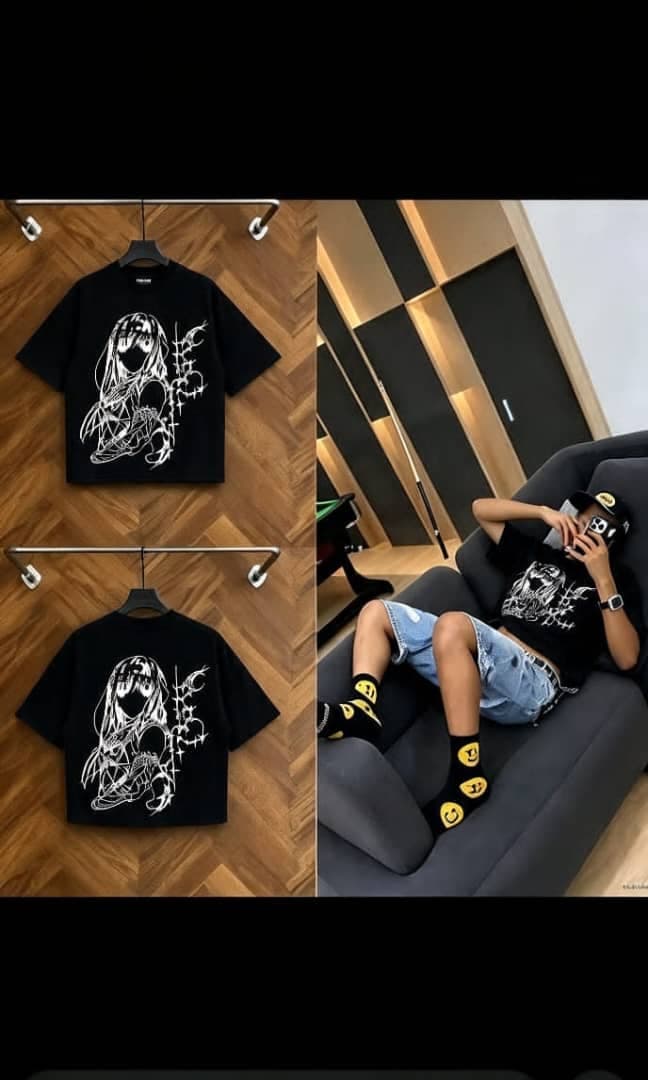 Black cropped t-shirt with anime girl and barbed wire graphic on front and back, shown on model relaxing.