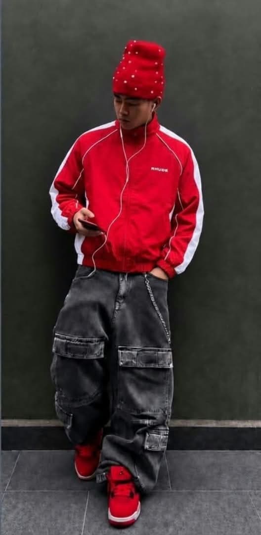 Red Rhude track jacket with white contrast sleeves and chest logo.