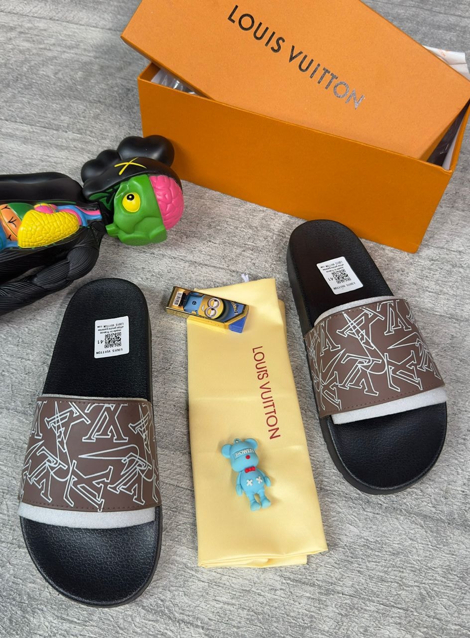 Brown LV monogram slides with orange box, yellow dust bag, and accessories on grey surface.