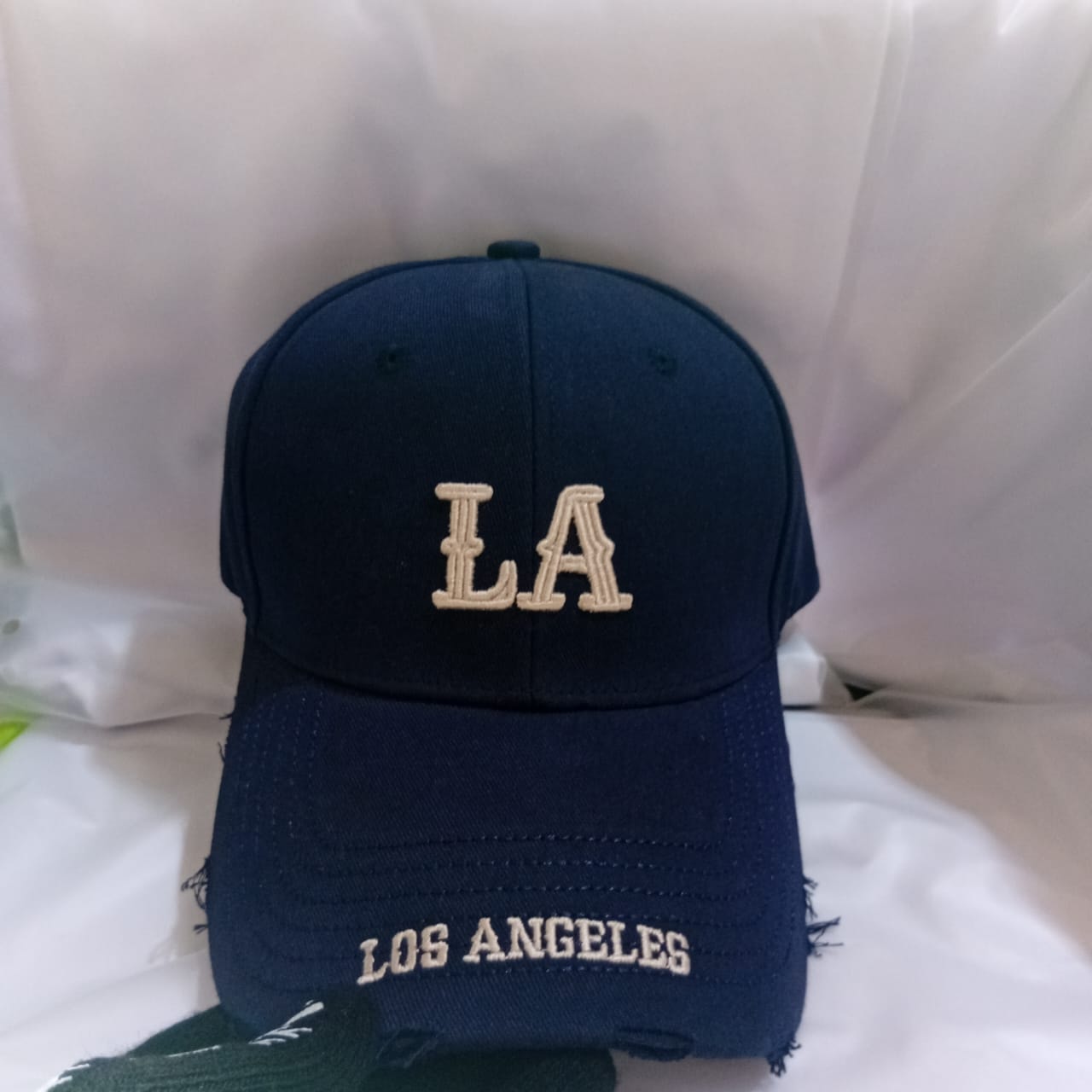 Navy LA Los Angeles embroidered cap with frayed brim.