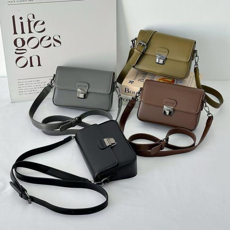 Crossbody bags with metal turn lock shown in gray, olive, brown and black.