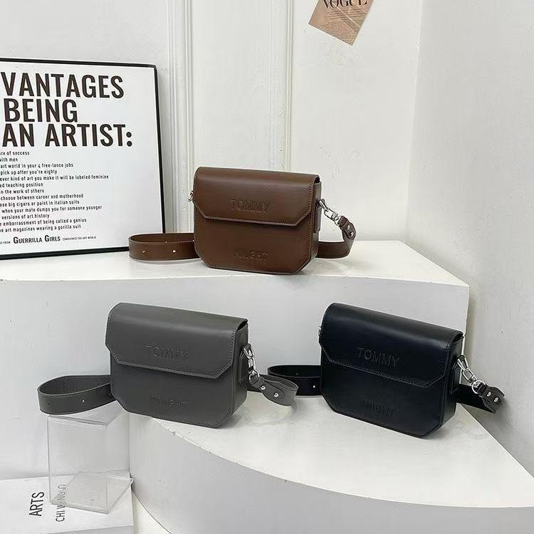 Tommy Hilfiger embossed crossbody bags shown in brown, gray and black colorways.