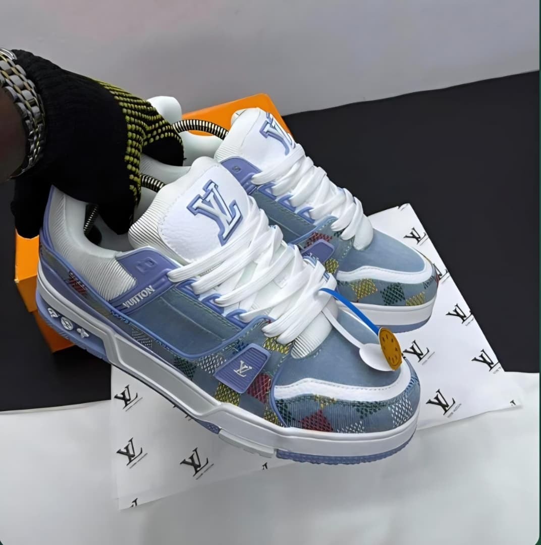 White blue and patterned Louis Vuitton sneakers displayed on branded paper with orange box.