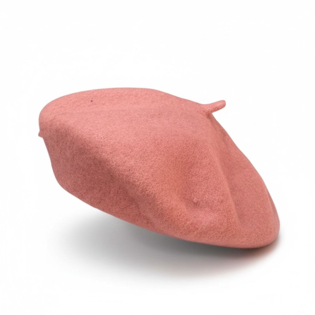 Pink wool beret on white background.