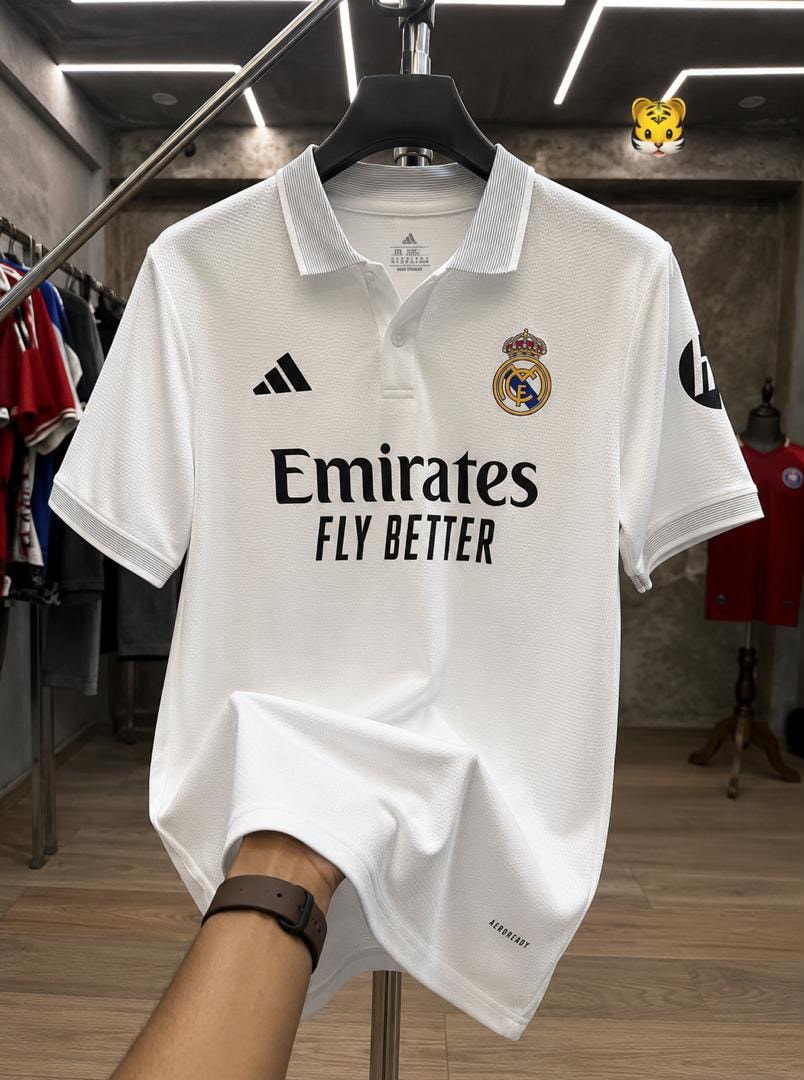 White Adidas Real Madrid polo jersey with Emirates Fly Better print.