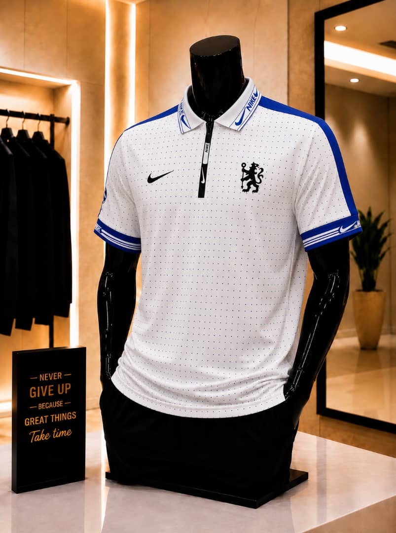 White Nike Chelsea polo jersey on mannequin in retail store.