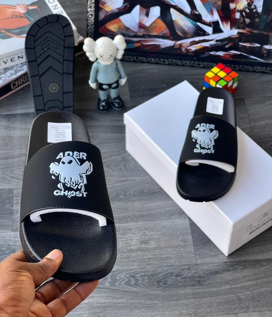 Black Ader Ghost slides held showing white graphic and text.