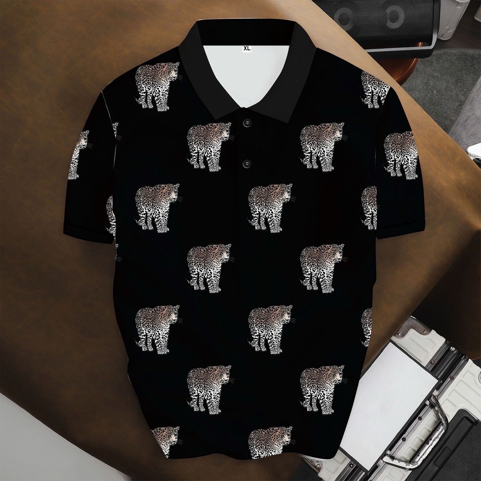 Black polo shirt with repeating leopard print pattern.