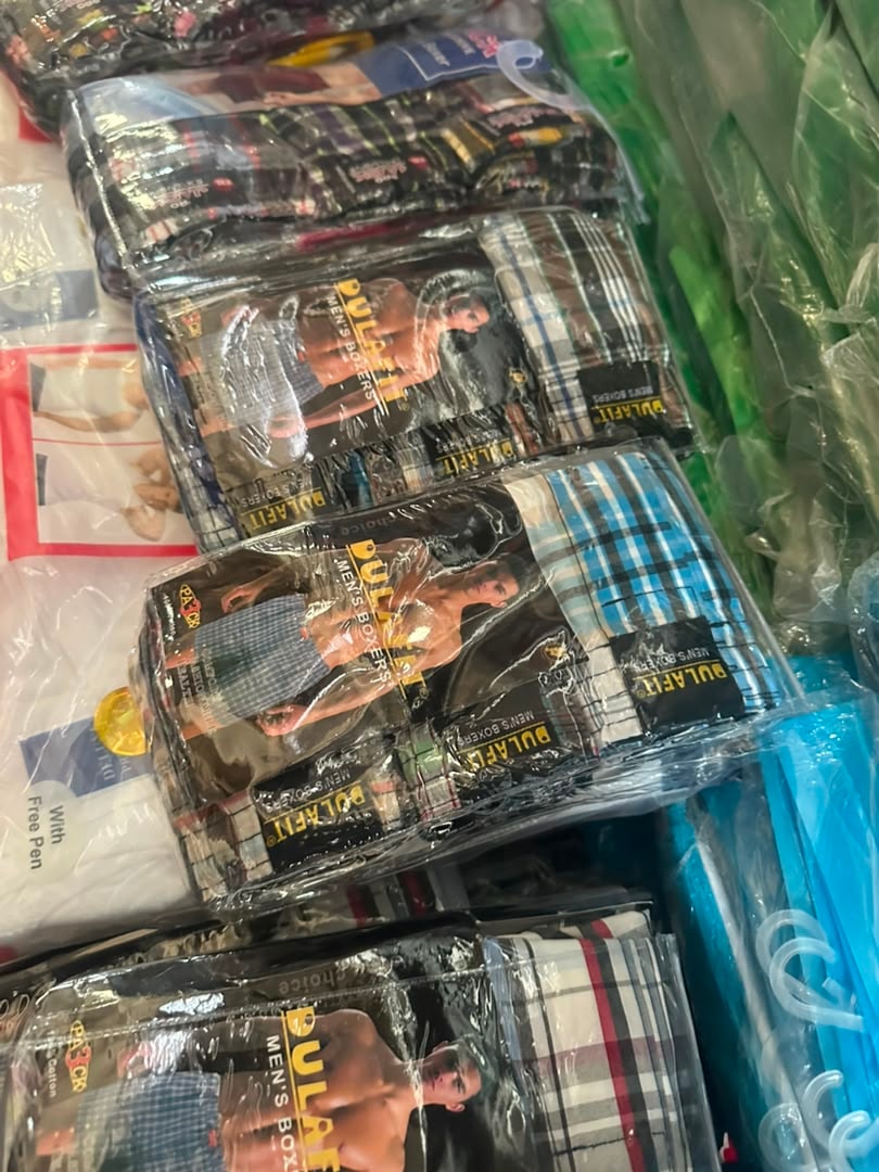 Multiple packaged Pulafit men's boxers in assorted plaid patterns.