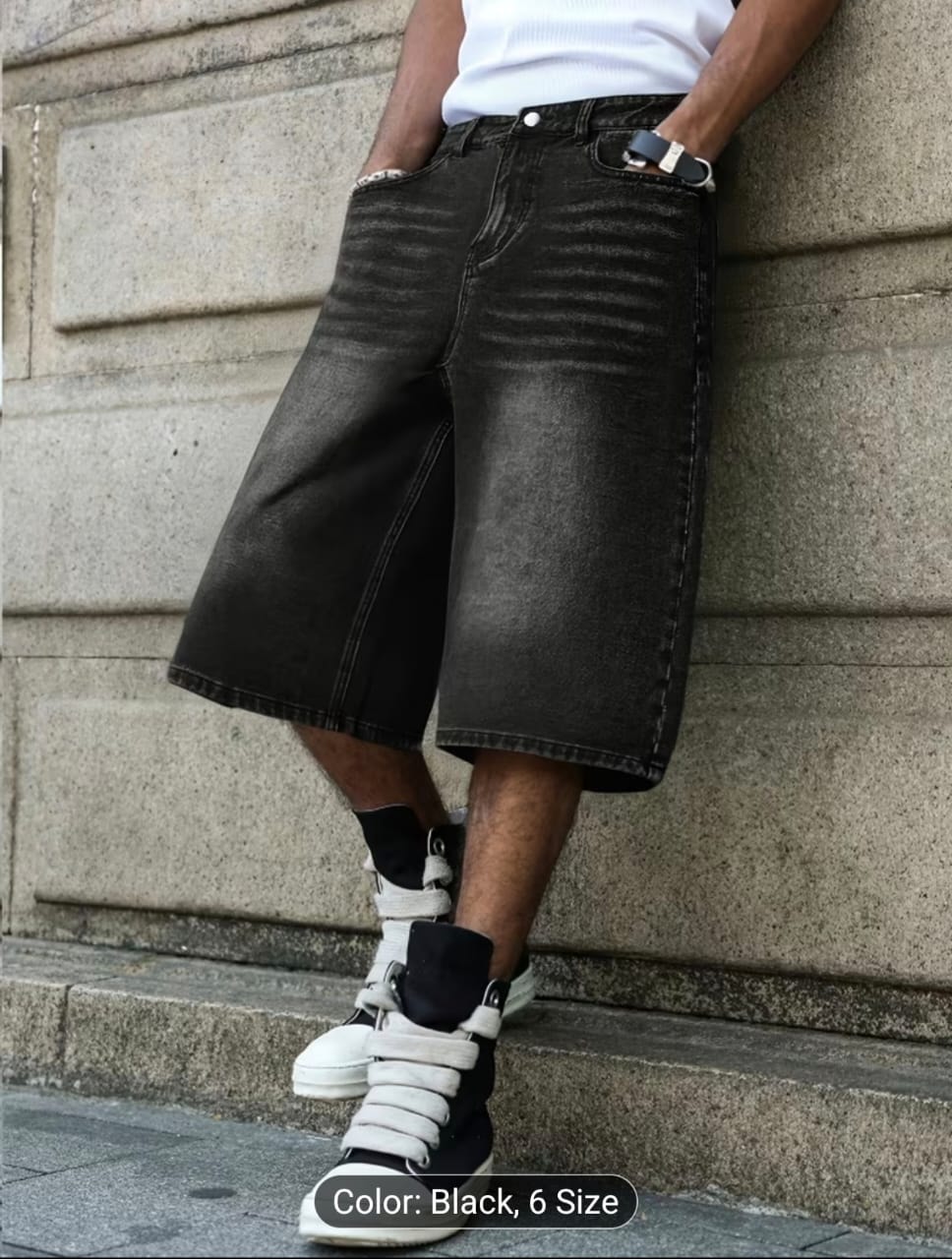 Model wearing black 3/4 length denim jort shorts with white top and sneakers.