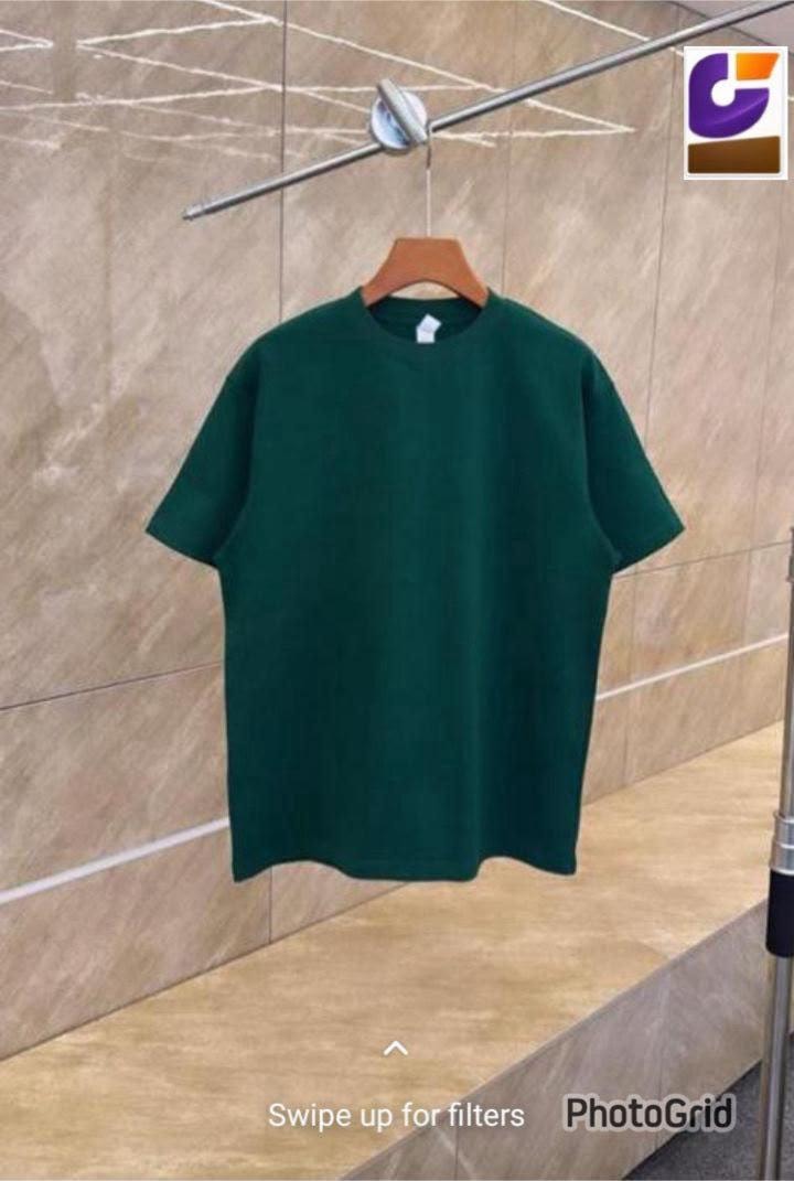 Dark green plain oversized T-shirt on wooden hanger.