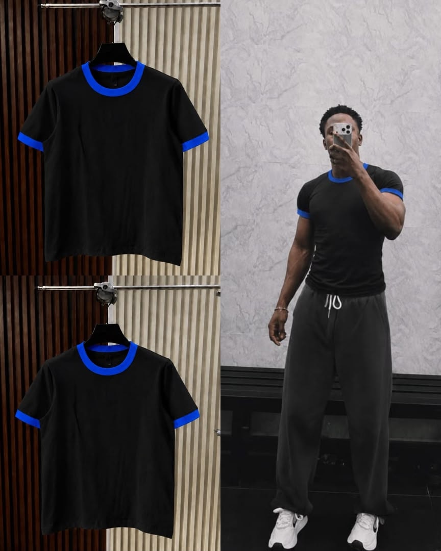 Black t-shirt with blue contrast trim on neck and cuffs, shown on hanger and model.