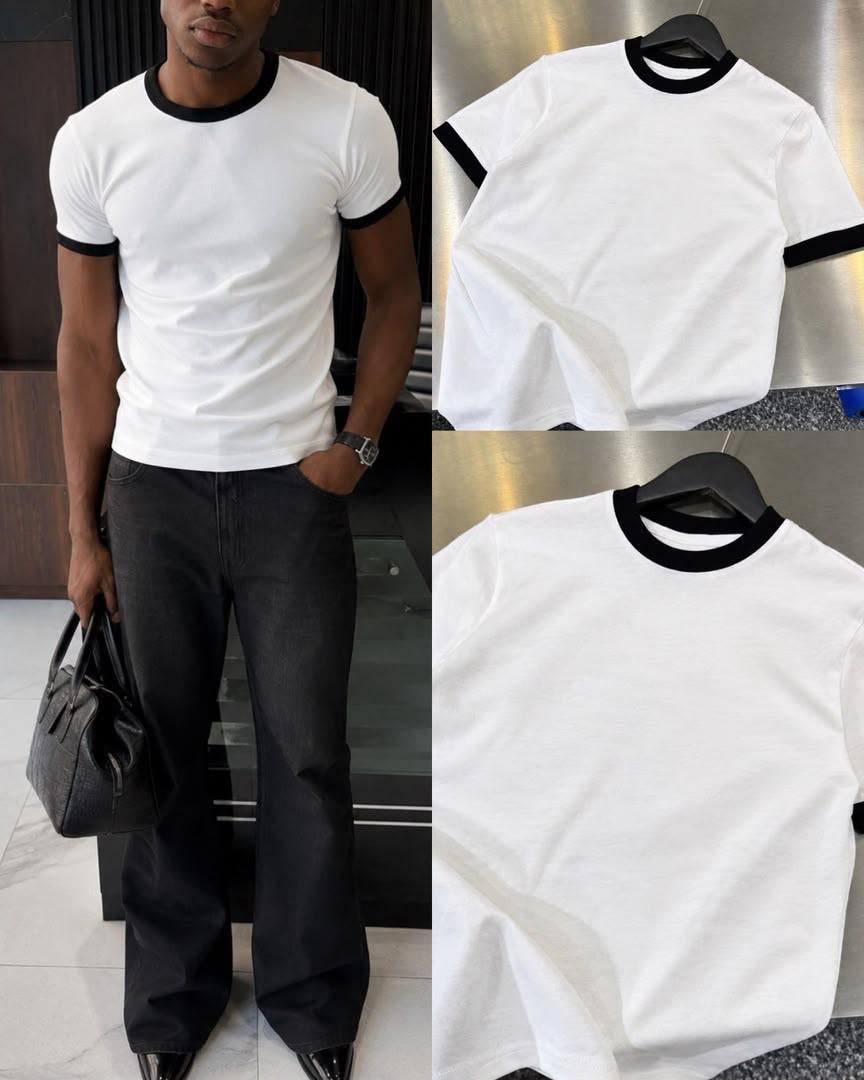 White t-shirt with black contrast trim on neck and cuffs, shown on hanger and model.
