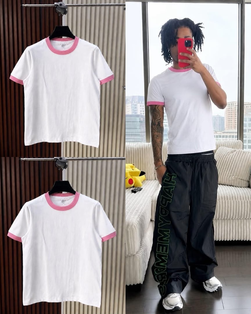 White t-shirt with pink contrast trim on neck and cuffs, shown on hanger and model.