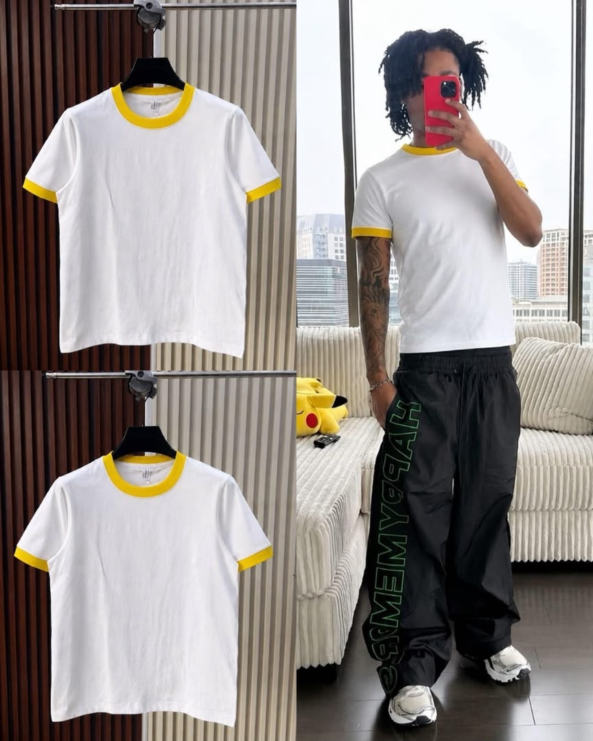 White t-shirt with yellow contrast trim on neck and cuffs, shown on hanger and model.