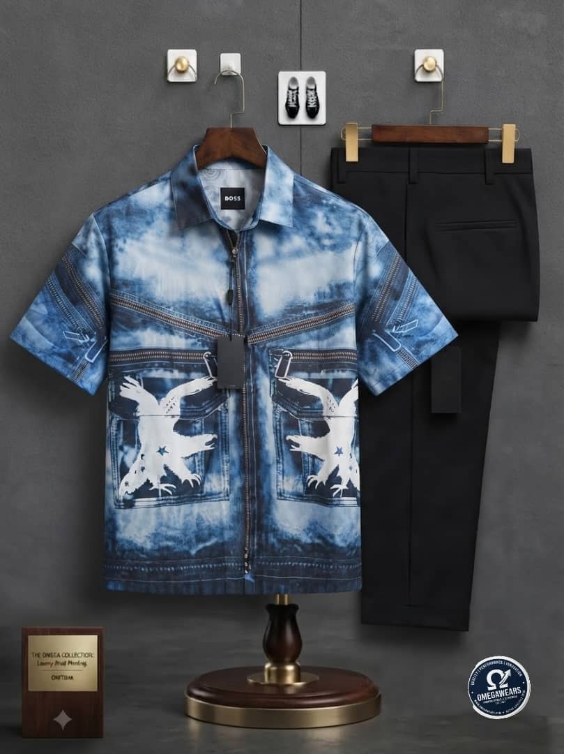 Blue tie-dye printed zip shirt with eagle design and black trousers.