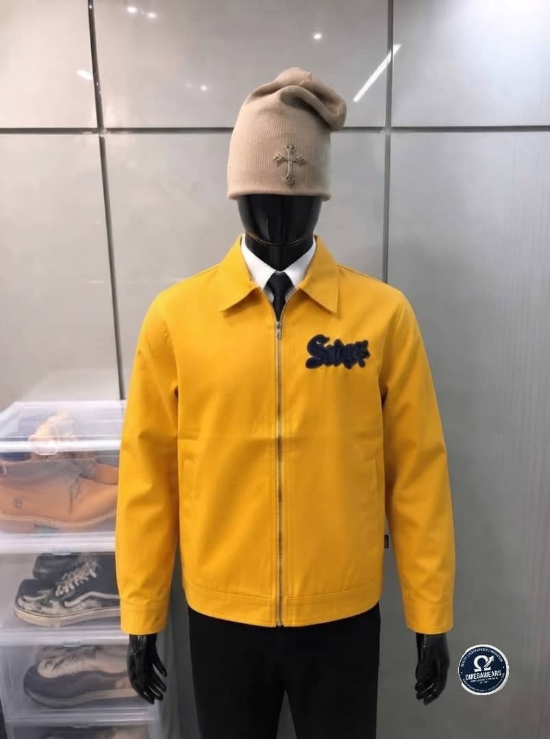 Yellow Swag embroidered zip-up jacket on mannequin.