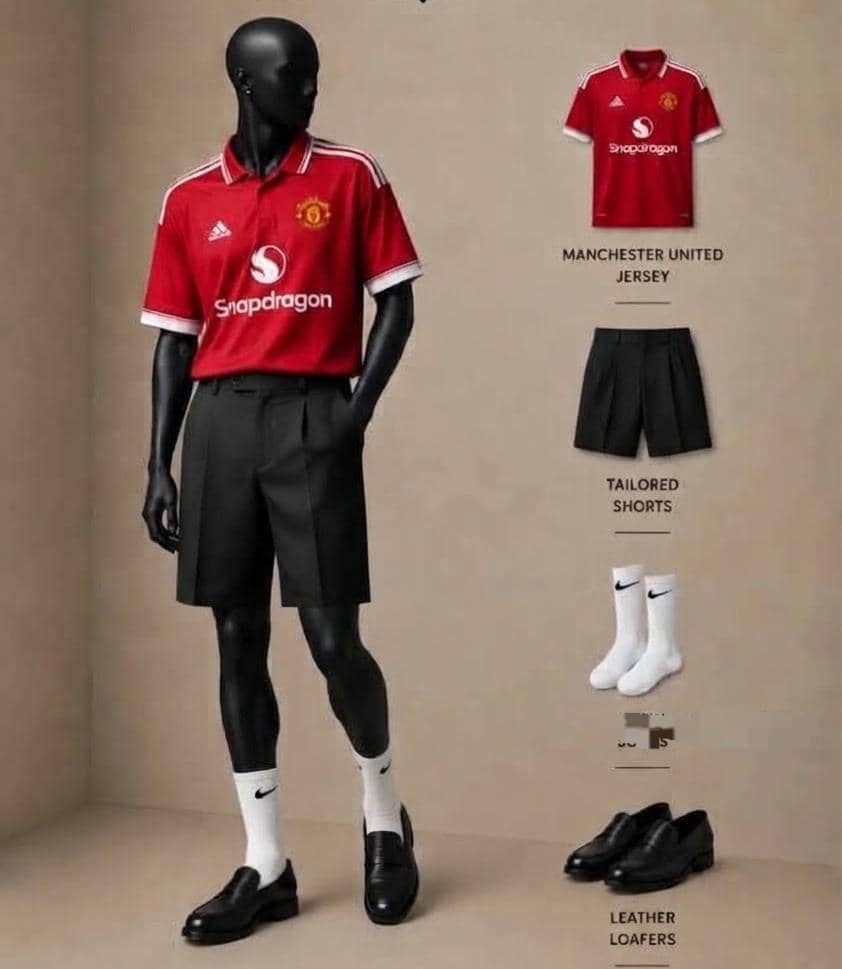 Mannequin in Manchester United red jersey with black pleated shorts, socks and loafers.