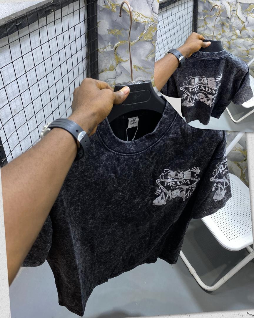 Black stone wash t-shirt displaying Prada Milano logo and graphics on chest and sleeve with back inset.