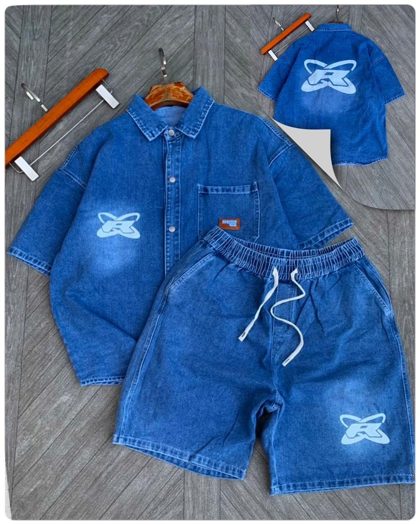 Flat lay of blue denim shirt and shorts with light blue spray logo print.