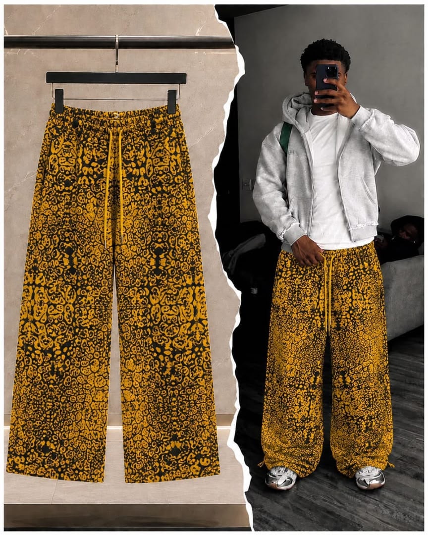 Yellow abstract print wide-leg joggers on model wearing with hoodie.