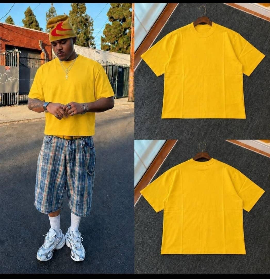 Yellow unisex crop top worn by model with front and back flat lay views.