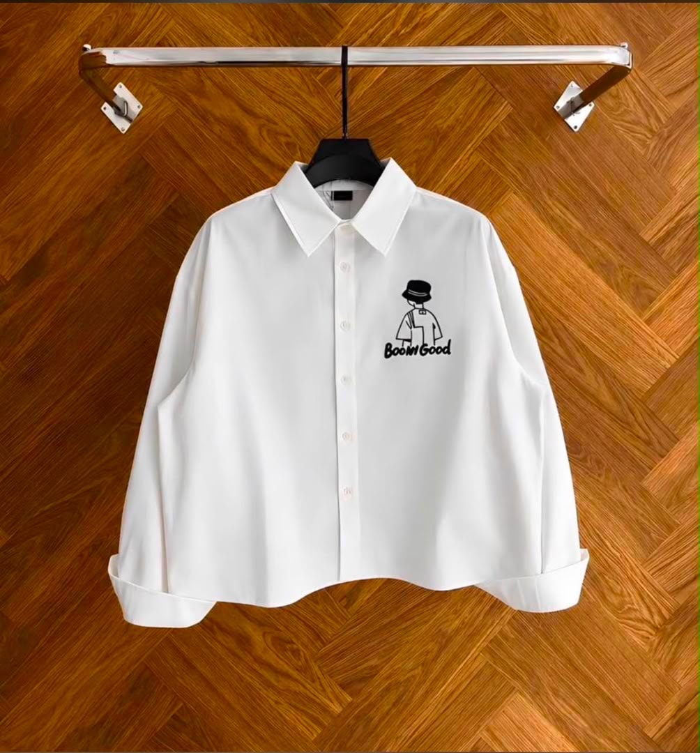 Front view of white cropped button-up shirt with Boom Good embroidery.