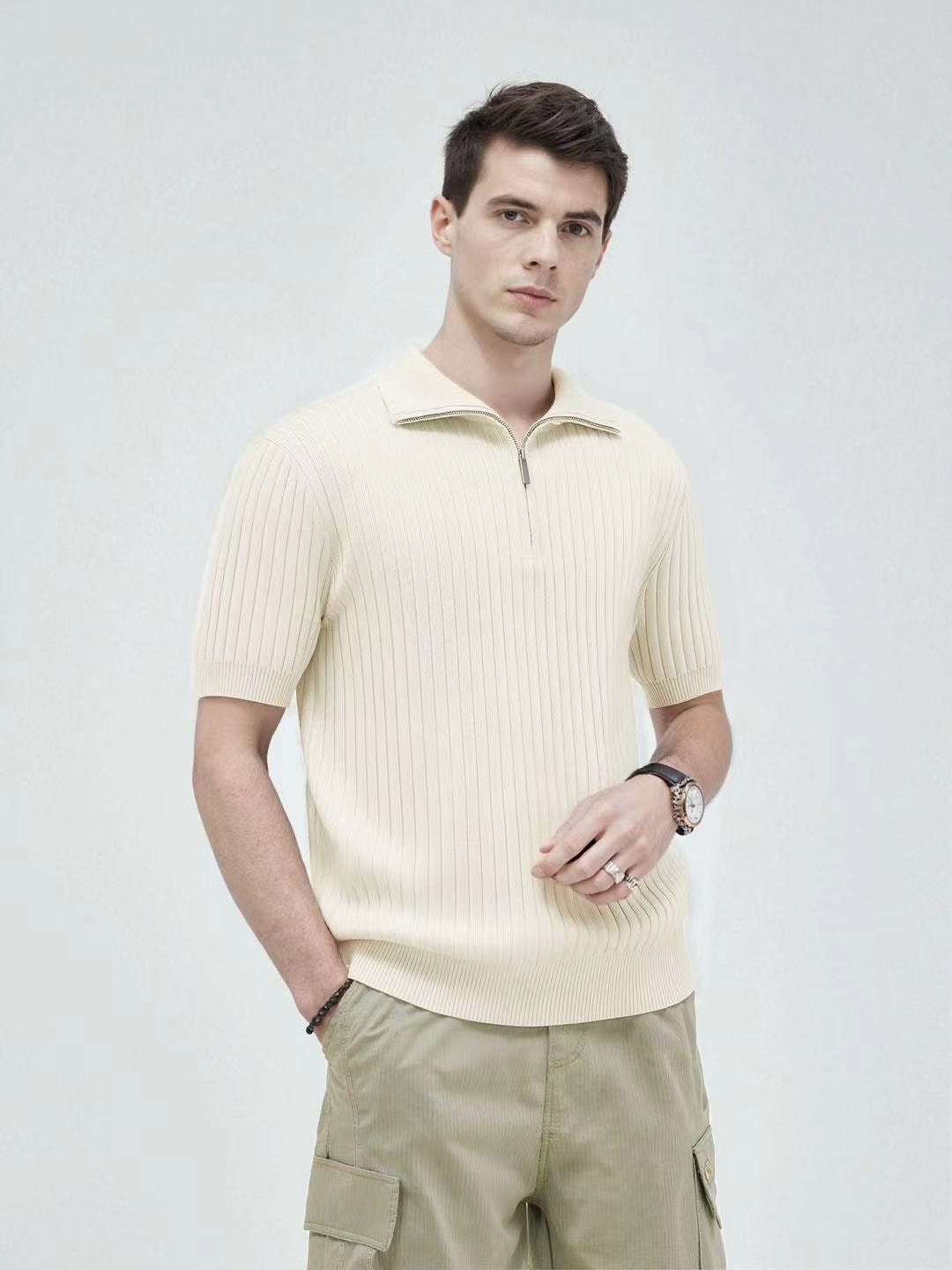 Man modeling cream ribbed knit quarter-zip polo shirt with cargo pants.