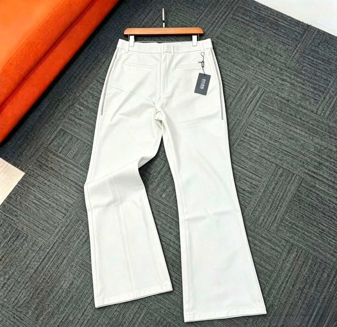 Back view of white flare trousers on hanger showing details and tag.