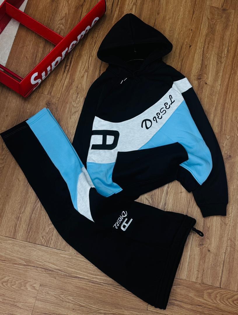 Black Diesel colorblock hoodie and matching joggers two-piece set on wooden floor.