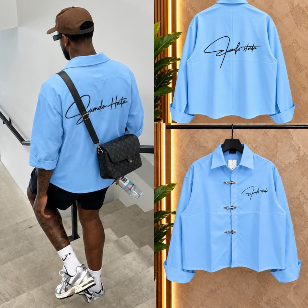 Man modeling light blue cropped toggle button shirt from back with product shots.