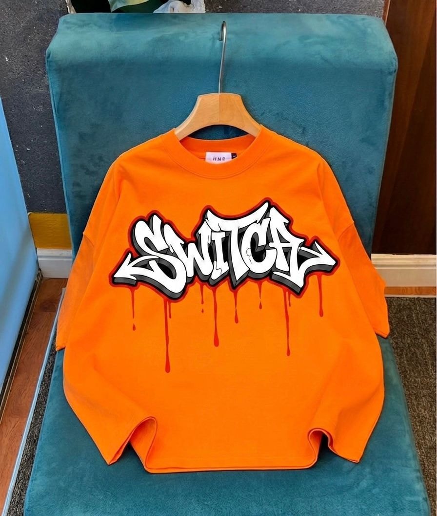 Orange long sleeve top with Switch graffiti print.
