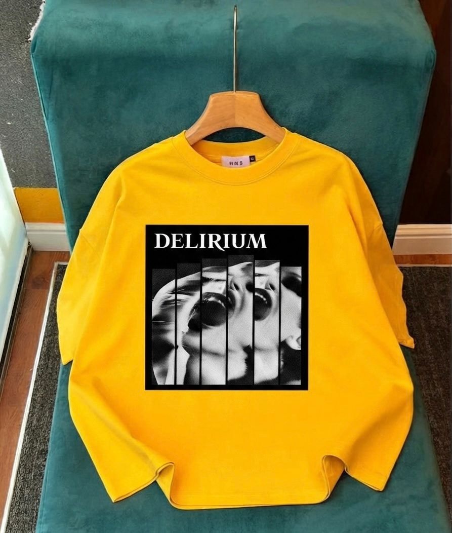 Yellow long sleeve top with Delirium split face graphic on chest.
