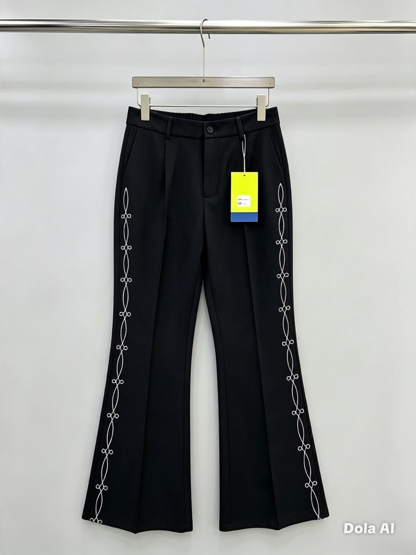 Black flare trousers with white chain embroidery along the side seams.
