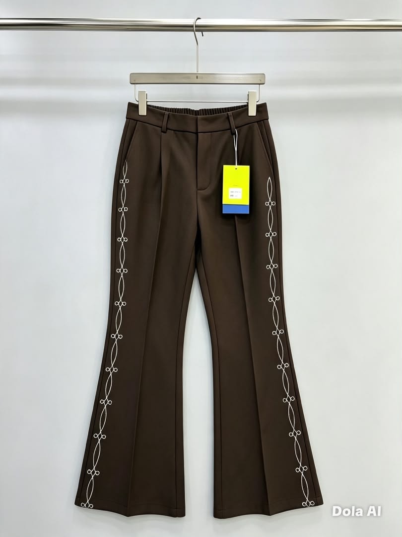 Brown flare trousers with white chain embroidery along the side seams.