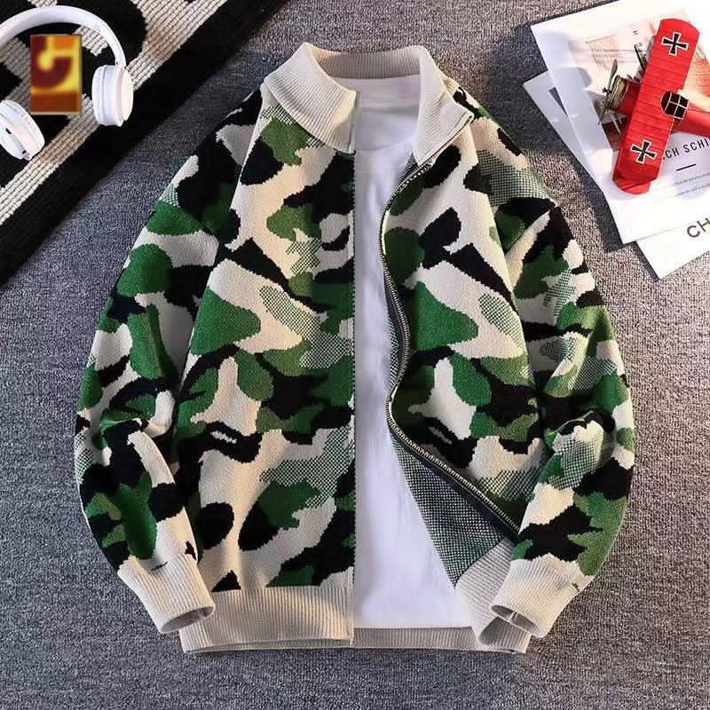 Camouflage knit bomber jacket in green, black and cream pattern over white tee.