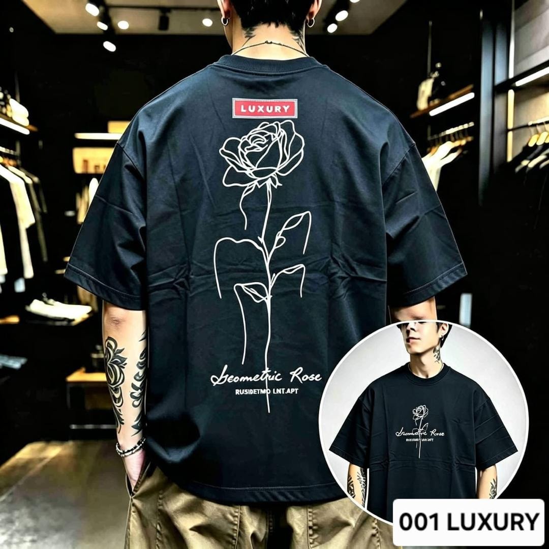 Man modeling black oversized t-shirt with geometric rose line art on the back.
