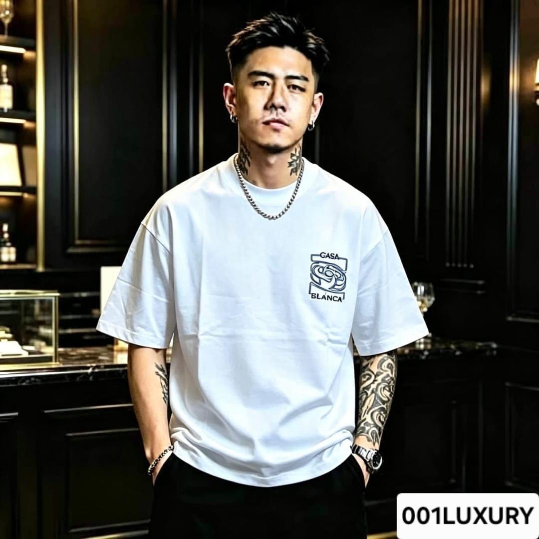 Man modeling white oversized t-shirt with Casa Blanca logo on chest.