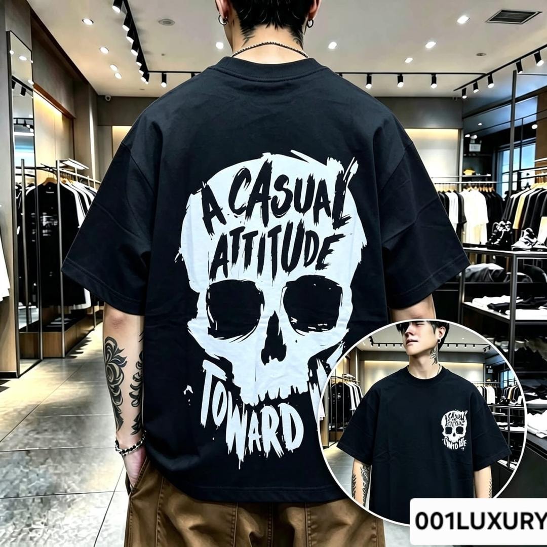 Man modeling black oversized t-shirt with large skull graphic on the back.