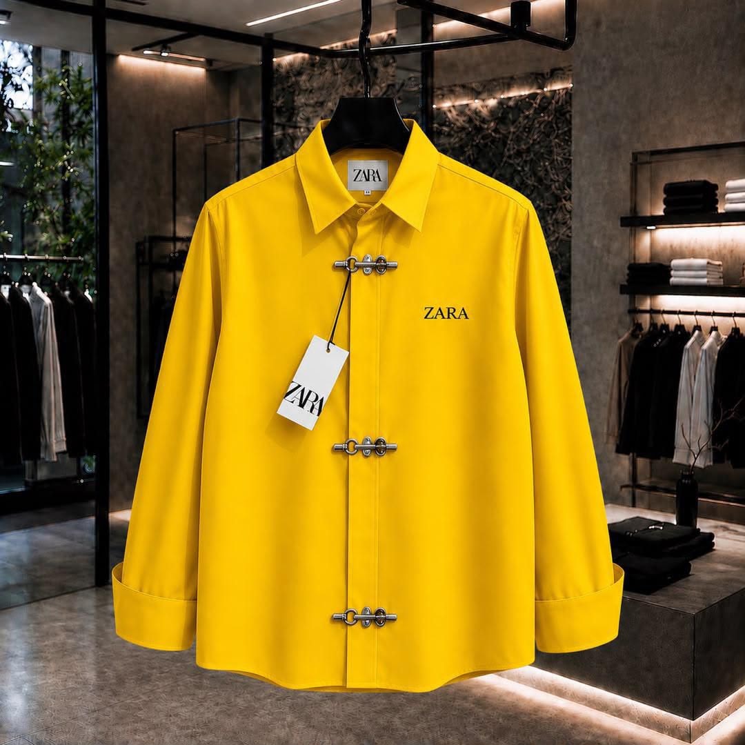 Yellow ZARA long sleeve shirt with toggle closures and chest logo in showroom.