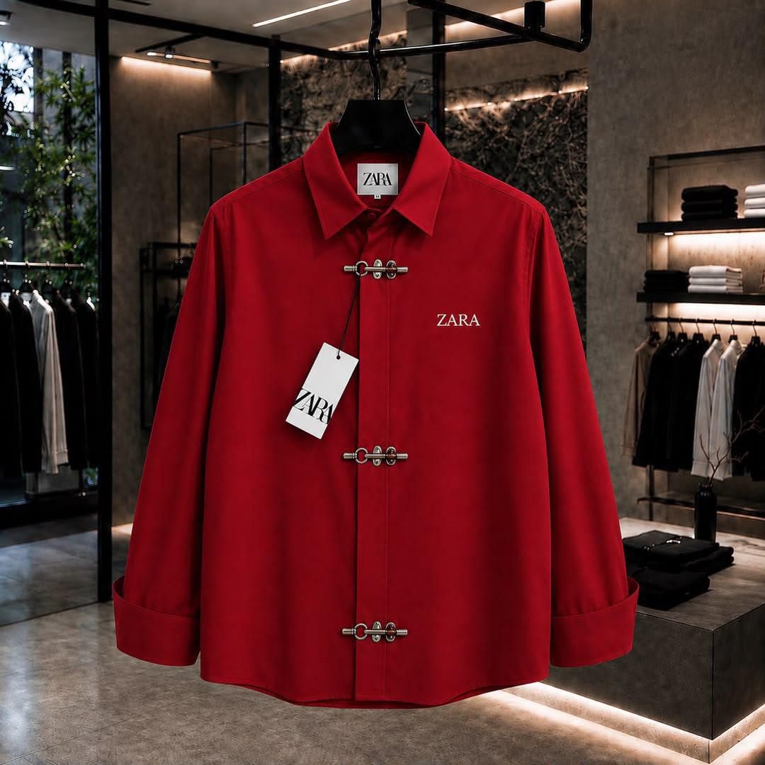 Red ZARA long sleeve shirt with toggle closures and chest logo in showroom.