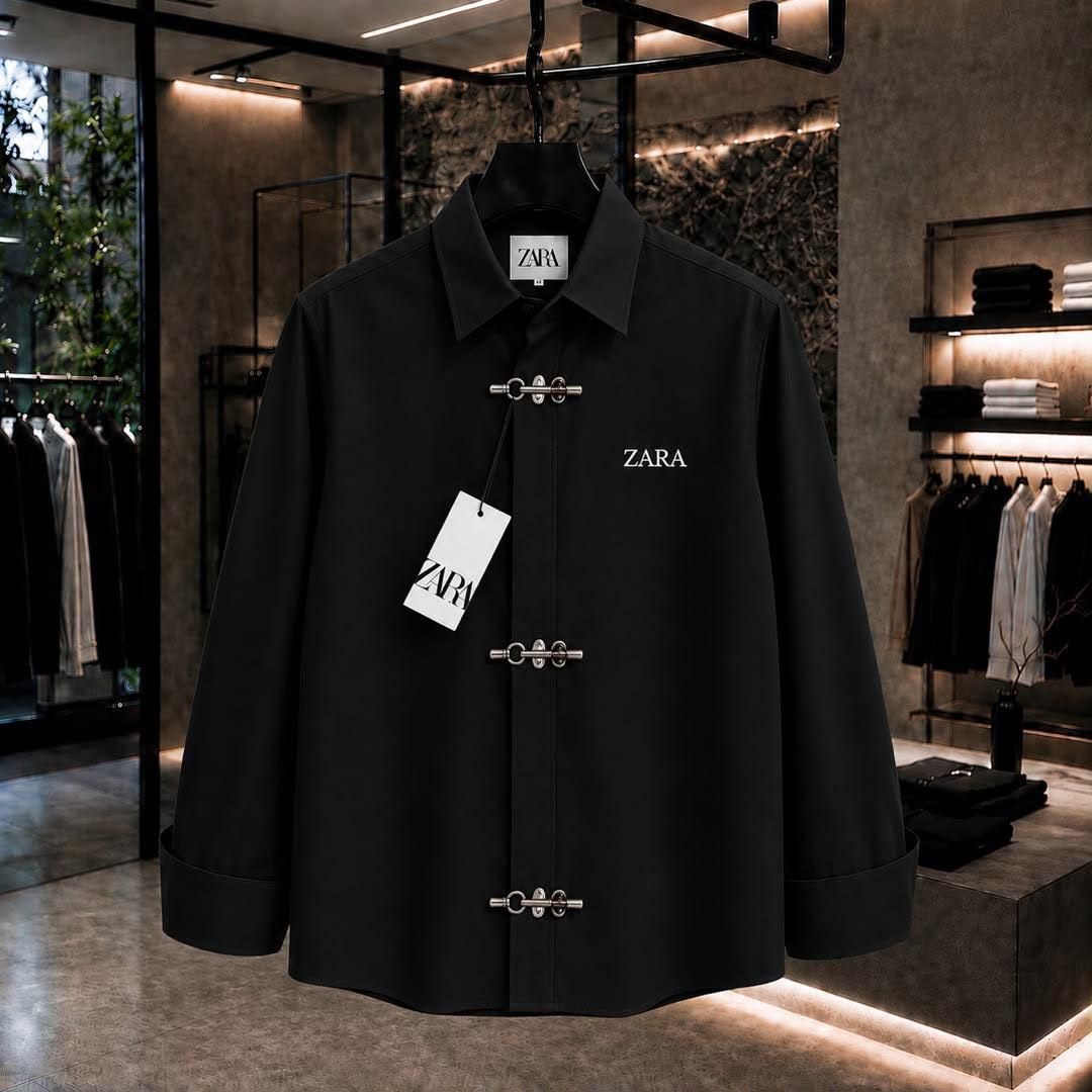 Black ZARA long sleeve shirt with toggle closures and chest logo in showroom.