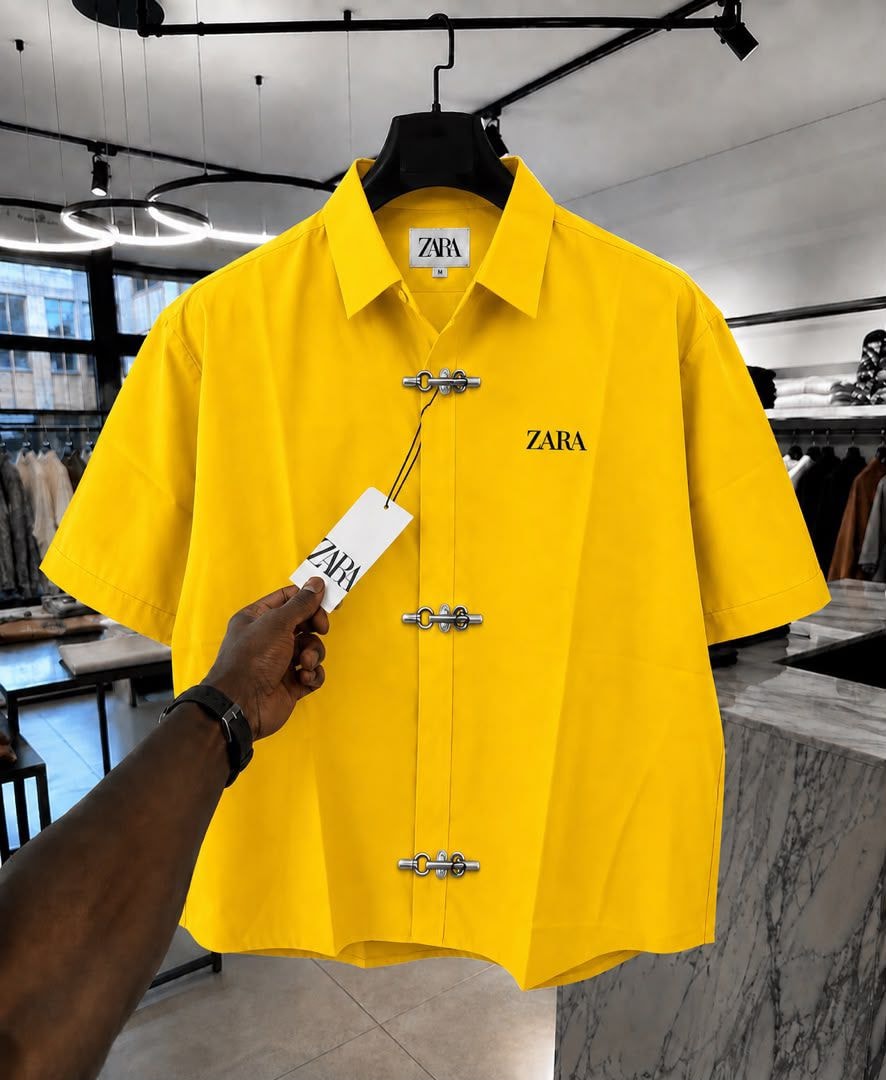 Yellow ZARA short sleeve shirt with toggle closures and chest logo.