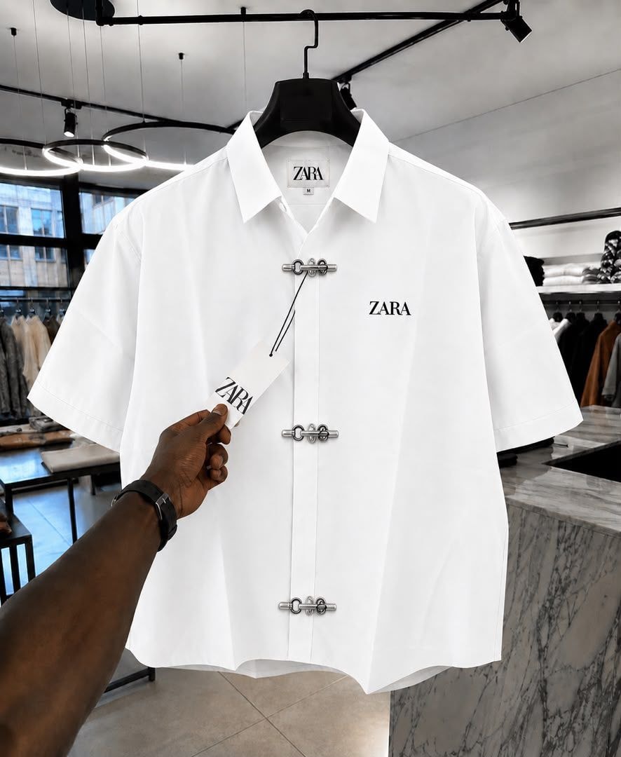 White ZARA short sleeve shirt with toggle closures and chest logo.