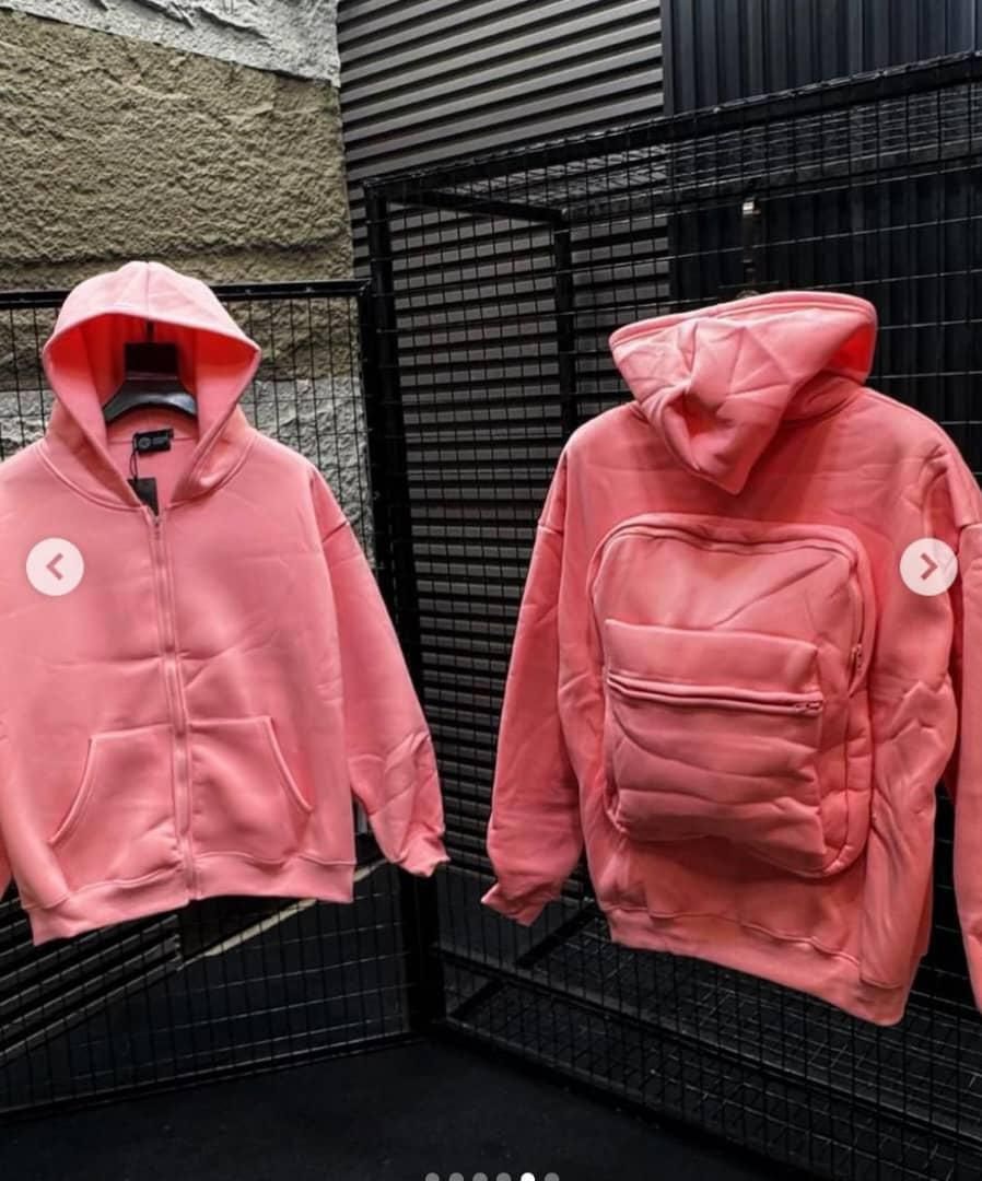 Pink zip-up hoodie shown from front with kangaroo pocket and back with large quilted utility pocket.
